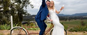 Wedding couple on a bike celebrating
